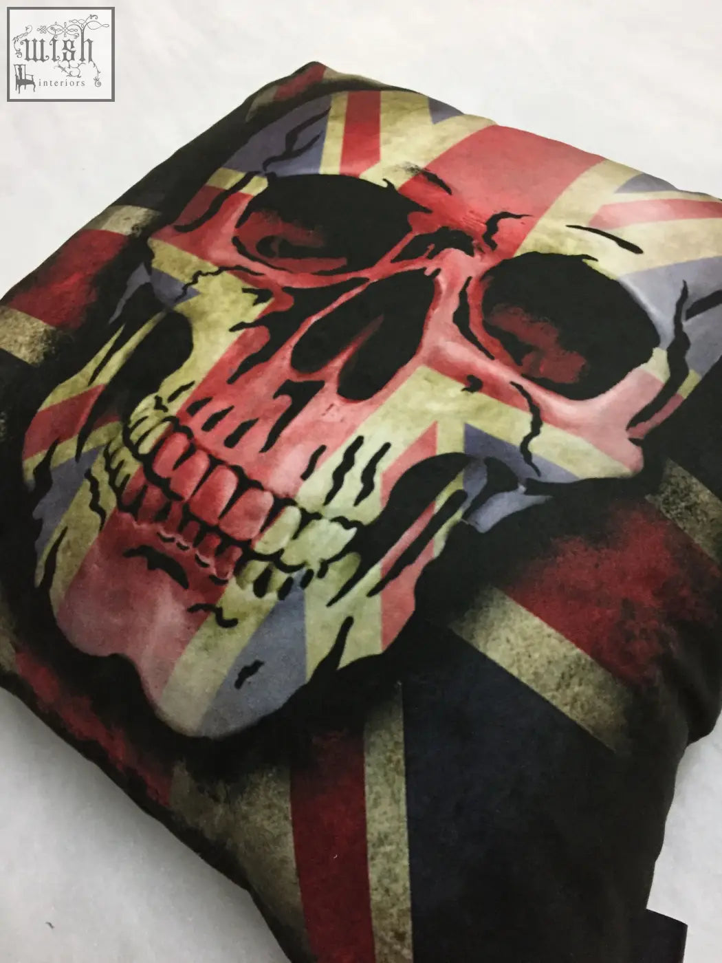 Dan gold union skull cushion with distressed skull and faded union jack flag in red white and blue tones on square fabric