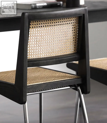 Black-framed dana rattan dining chair with woven natural fiber seat and back and sleek metal legs