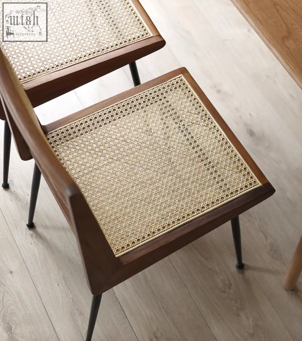 Dark wood framed dana rattan dining chair with woven cane seat and black metal legs perfect for dining chairs