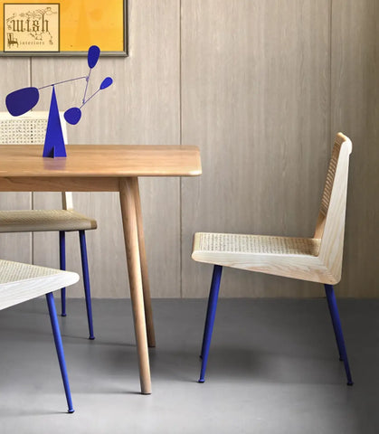 Modern dana rattan dining chair with woven cane seat and back and vibrant blue metal legs for stylish dining chairs