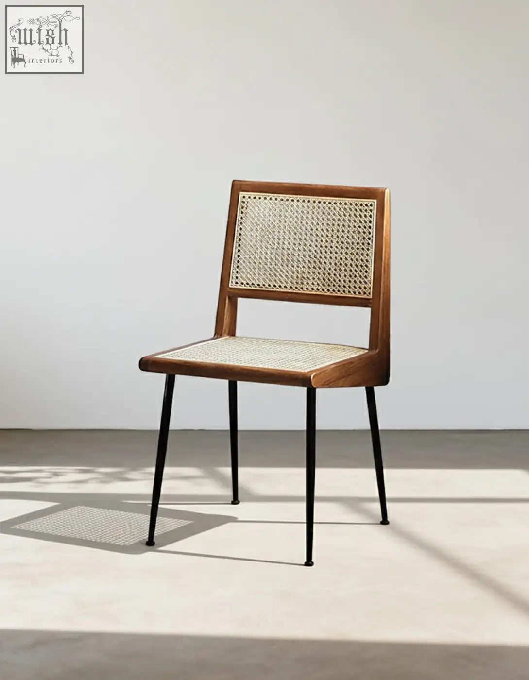 A dana rattan dining chair with sleek wooden frame, woven cane back and seat, and slender black metal legs