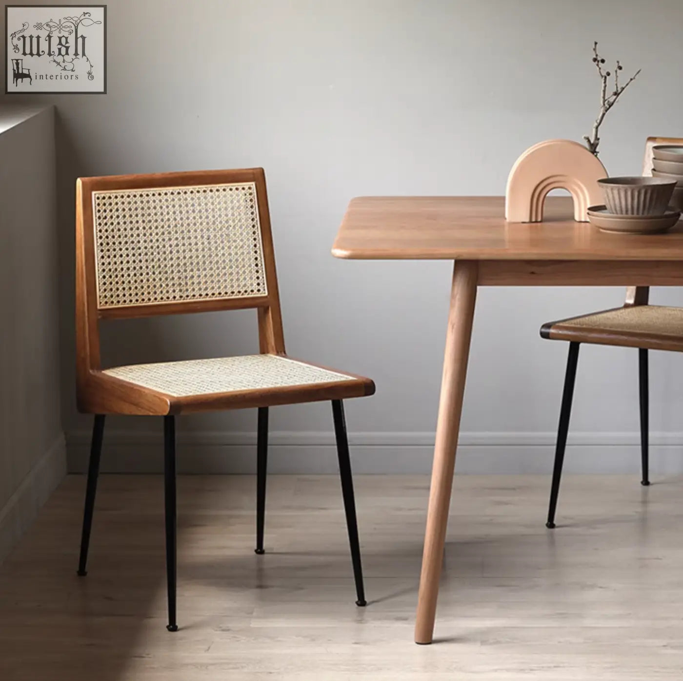 Dana rattan dining chair with woven cane back and seat and dark metal legs perfect for stylish dining chairs