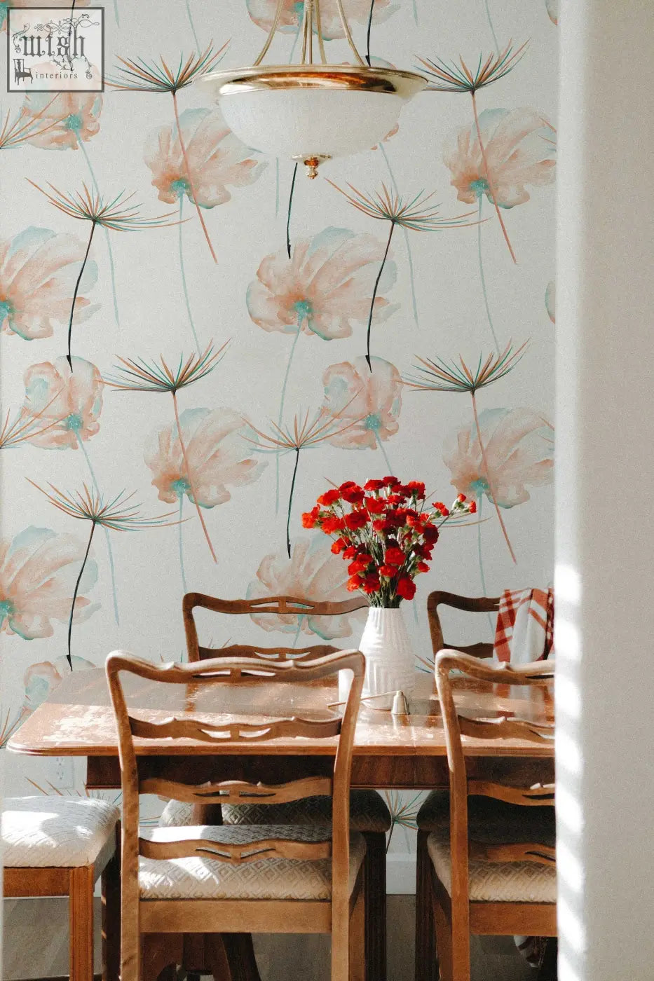 A white ceramic vase with red flowers complements teal floral peel and stick wallpaper for easy living space updates