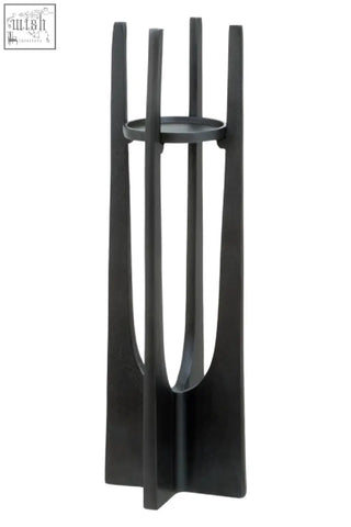 Black metal umbrella stand with sleek modern design and vertical slats shown with large grey pillar candles candle holder