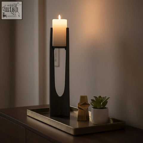 Black minimalist large grey candle holder with sleek modern design holding an ivory pillar candle