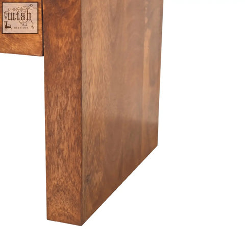 Solid wood table leg with warm medium brown chestnut finish and natural grain on darcy chestnut bedside table