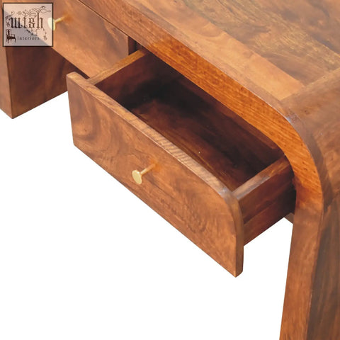 A rich warm-toned darcy chestnut coffee table with curved edges and two drawers featuring brass-colored knobs