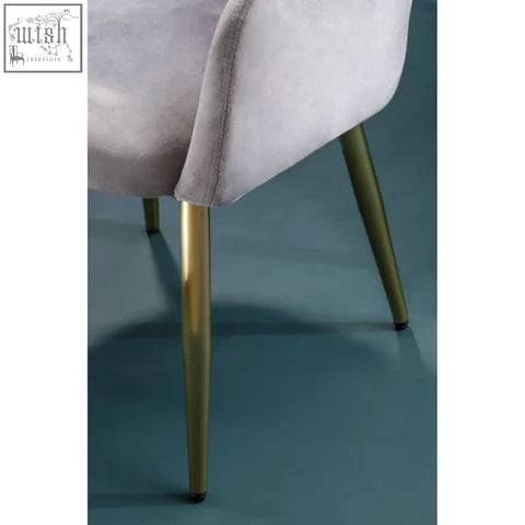 A plush lavender velvet dining chair with slender gold-tone metal legs perfect for stylish grey velvet dining spaces