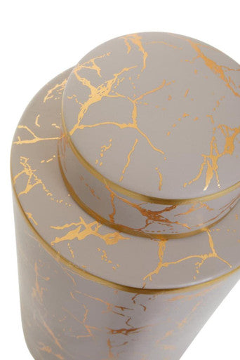 A sleek daria large ceramic jar with a white and gold marble pattern and matching lid for stylish tea storage