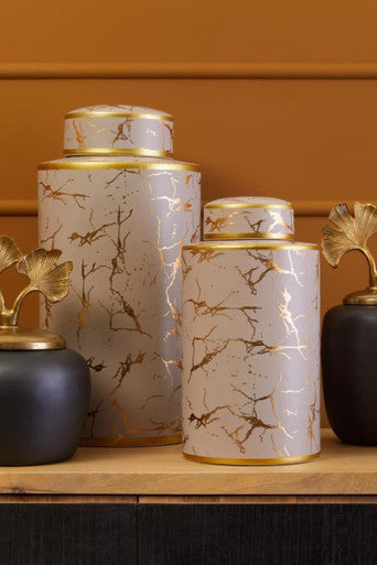 Two daria large ceramic jars with white marble patterns and gold accents each with matching lid large ceramic jar