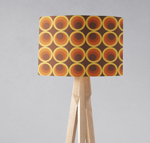 Dark brown retro 1970s table lamp shade with concentric circle pattern in orange yellow and brown on dark background