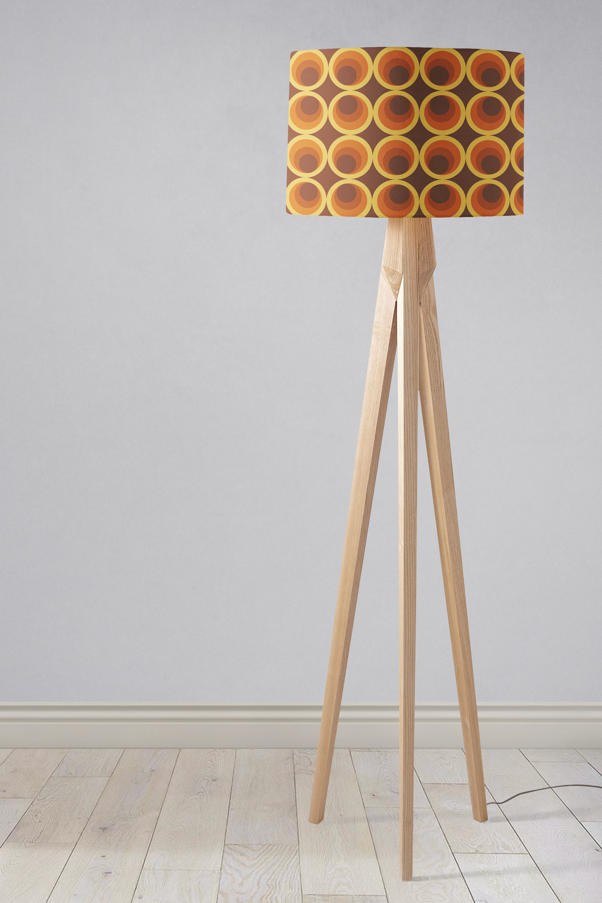 Dark brown retro 1970s table lamp with a cylindrical lamp shade featuring orange and yellow circles on wooden legs