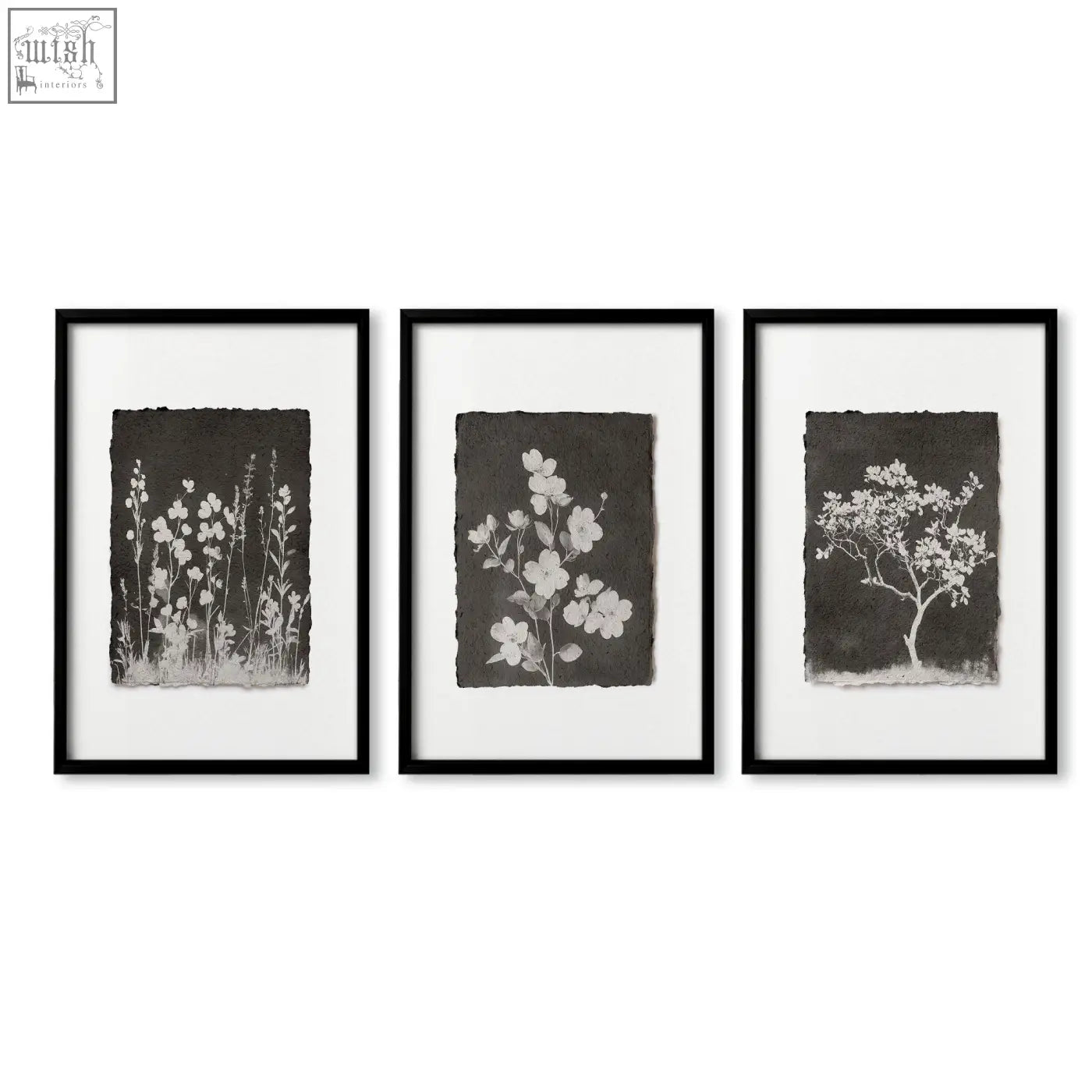 Set of three black-framed botanical wall art prints with white floral silhouettes on textured dark brown paper for brown wall art