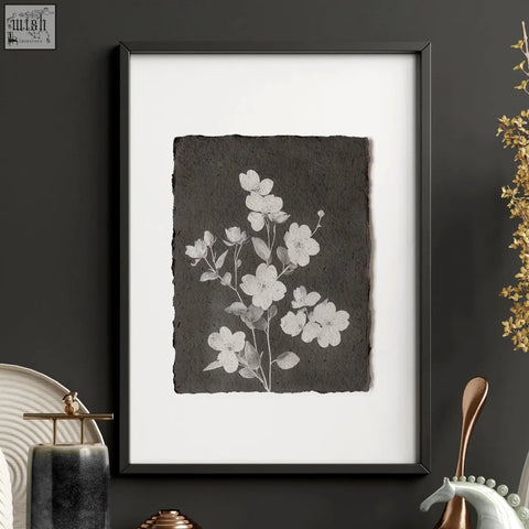 Black-framed wall art featuring delicate white floral illustration on textured dark paper perfect for brown wall art decor