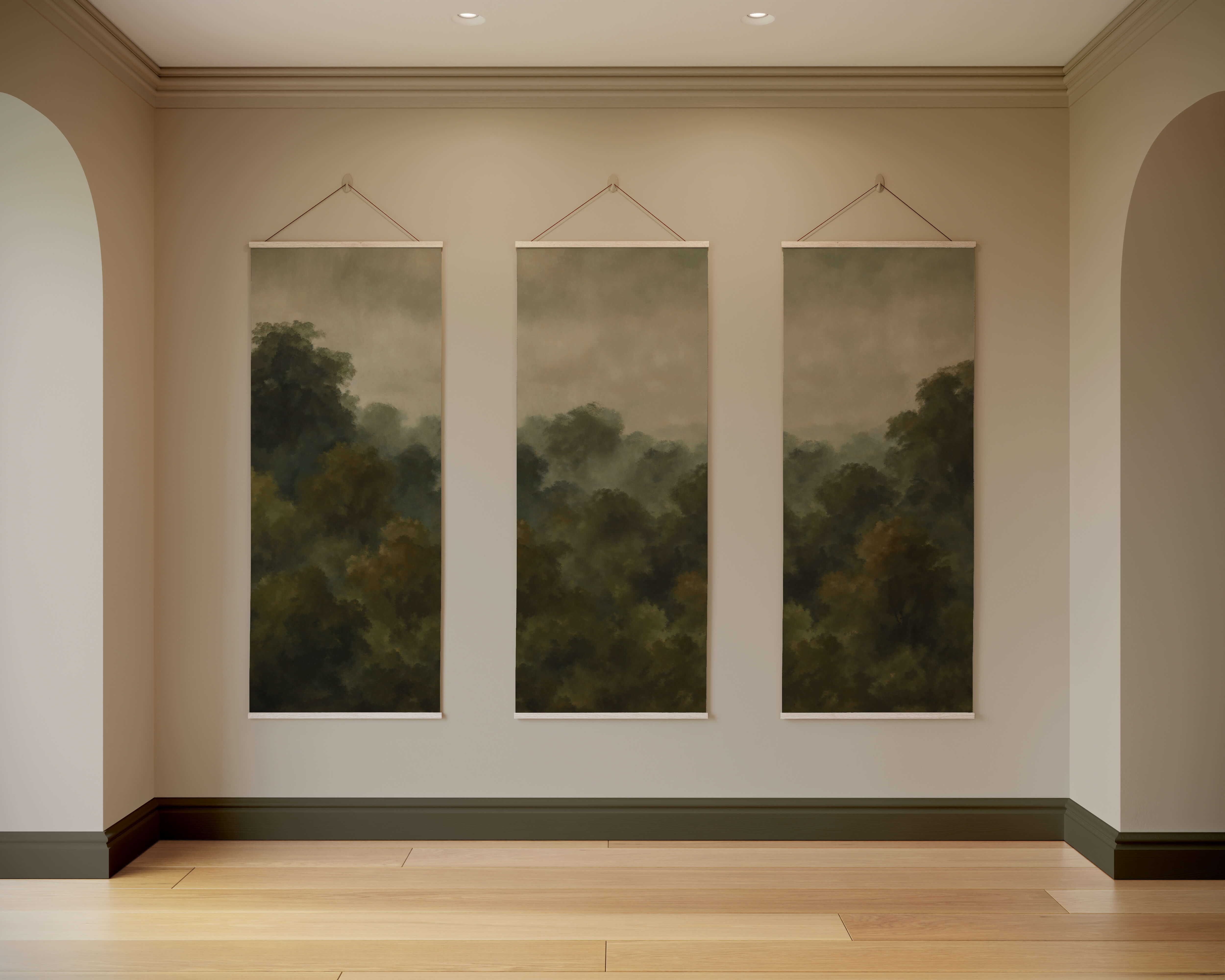 Three rectangular forest tapestry paintings in muted green and brown tones create a dark forest vibe on a light wall