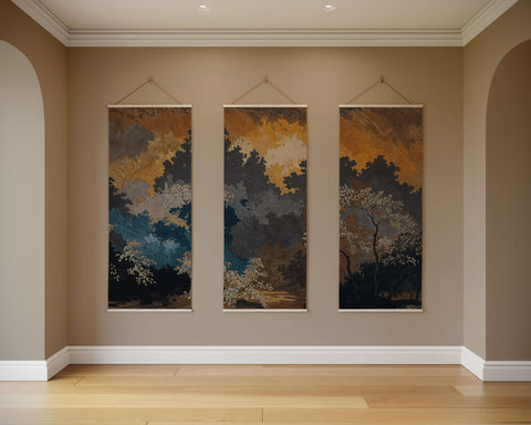 Three vertical dark oriental forest tapestries with warm ochre deep blue and white tones hanging on the wall