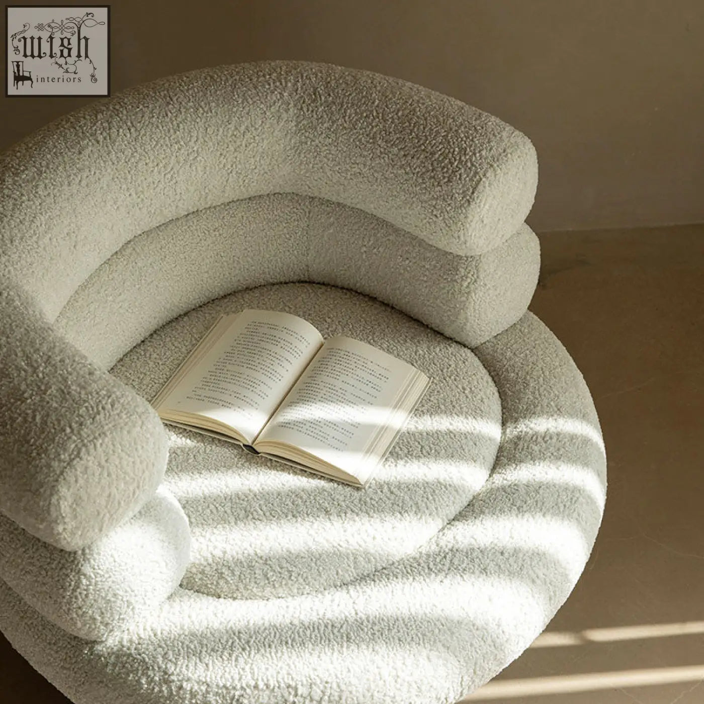 A cozy cream-colored darlene armchair made of soft boucle with a plush textured surface and curved layered design