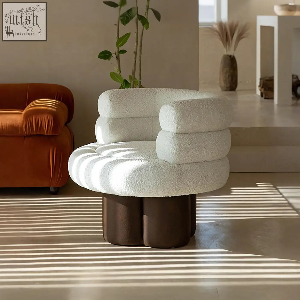 Cream-colored plush darlene armchair in boucle with a cloud-like design and dark brown cylindrical base