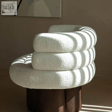 Darlene armchair in off-white boucle with plush tufted fabric and dark brown cylindrical base perfect for cozy seating