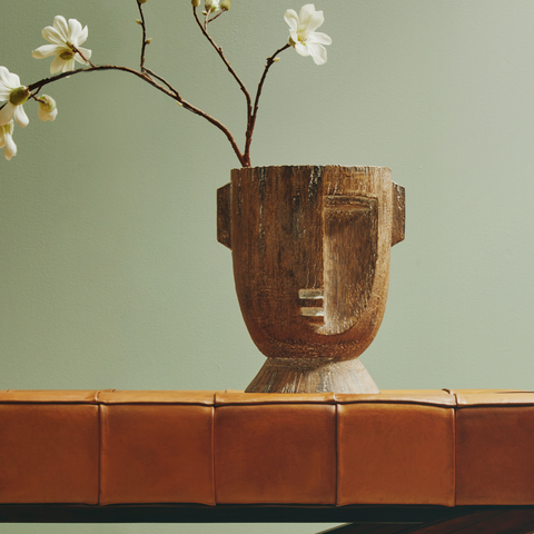 A rustic darnell small natural wooden vase shaped like a textured small natural face planter with carved features