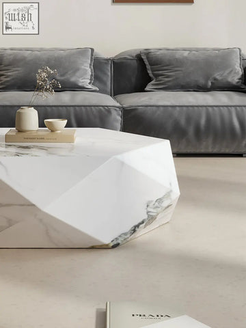 Geometric white marble darwin coffee table with sleek faceted design and subtle gray veining in sintered stone