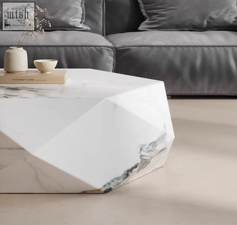 Modern darwin coffee table in white sintered stone with gray veining and geometric faceted design coffee table