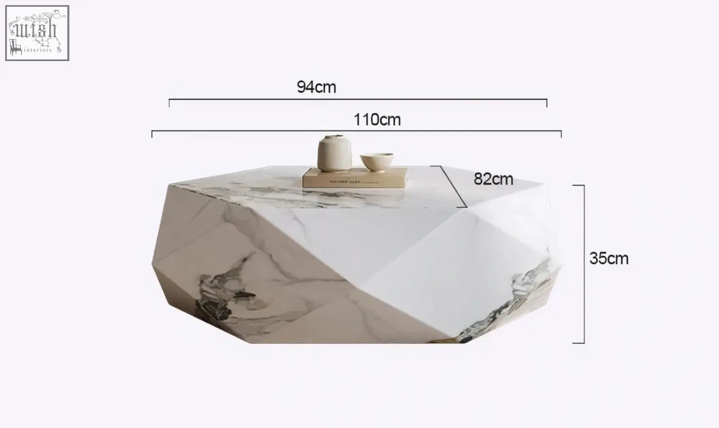 A modern darwin coffee table with a white and gray sintered stone top featuring geometric angular facets