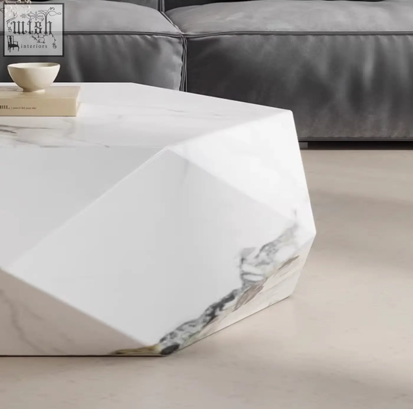 A modern white marble darwin coffee table with geometric edges and subtle gray veining made of sintered stone