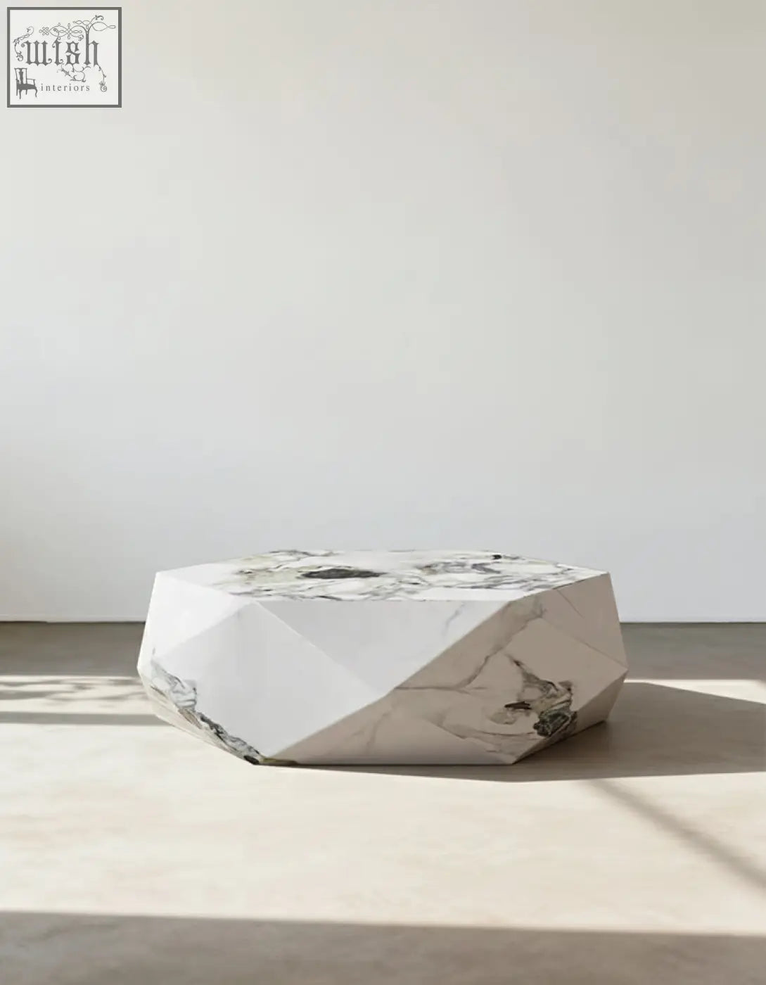 A sleek darwin coffee table with white marble top and gray veining made from durable sintered stone