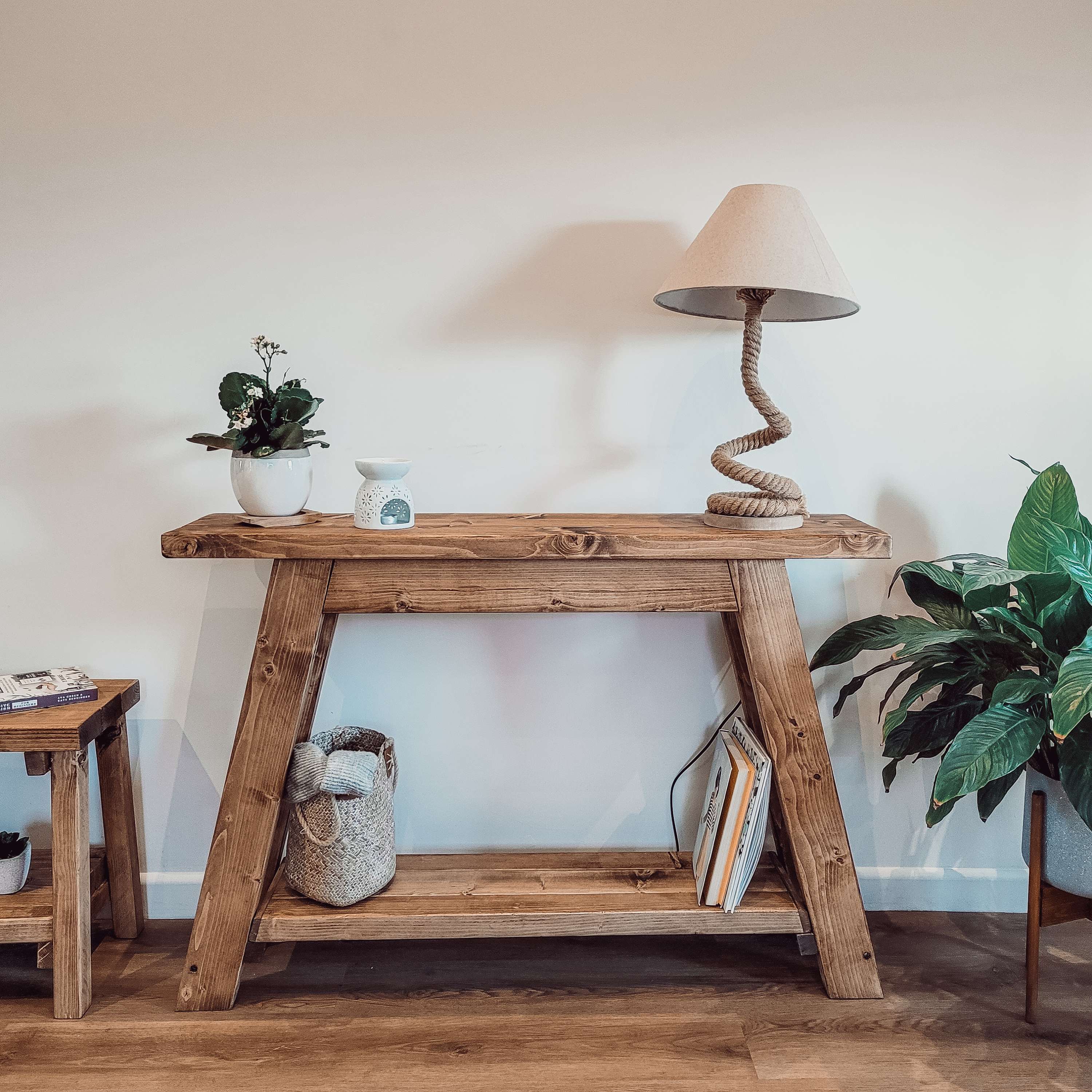 Rustic wooden dasi console table with sturdy a-frame design natural wood grain finish and built-in shelf