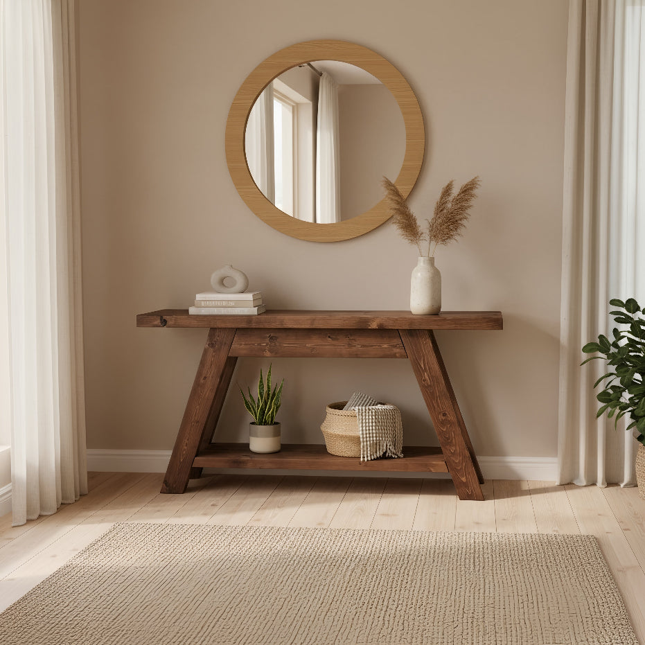 Round wooden-framed mirror with natural finish above the dasi console table with shelf walnut colour