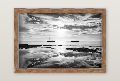 A rustic wooden frame fine art photograph by david ballam of a black and white coastal scene with two sailboats on calm waters