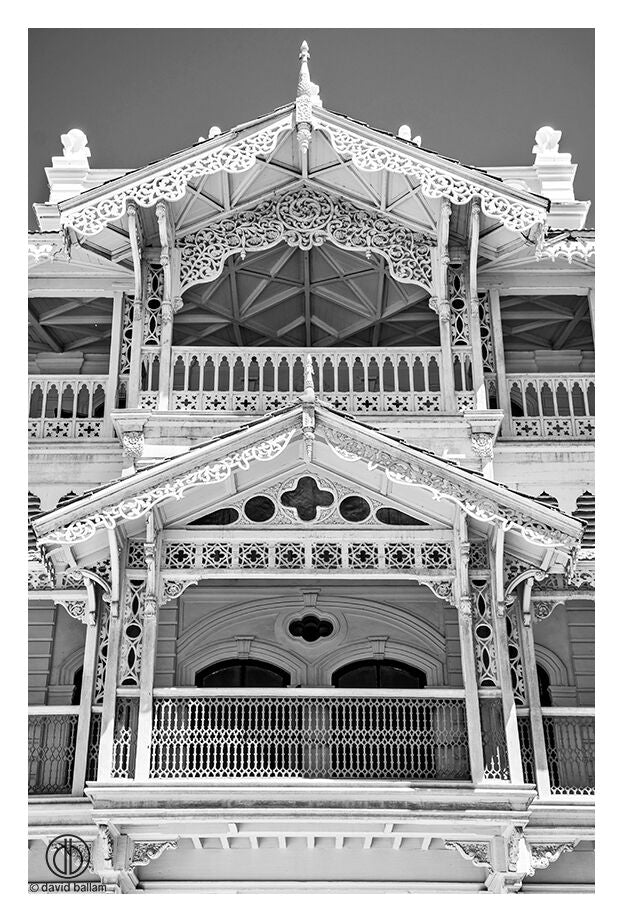 David Ballam fine art featuring an ornate white wooden balcony with intricate lace-like carvings and decorative trim