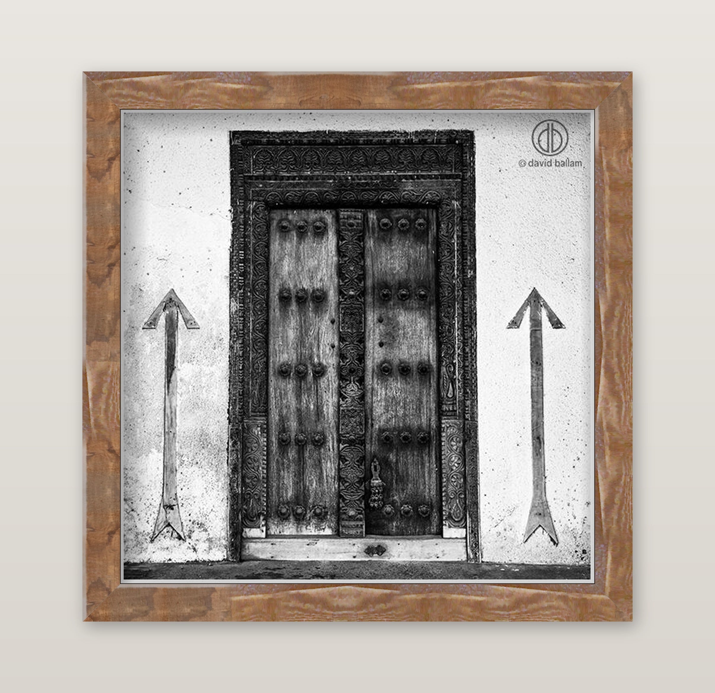 Black-and-white fine art photo by david ballam of an ornate double wooden door with intricate carvings and metal studs
