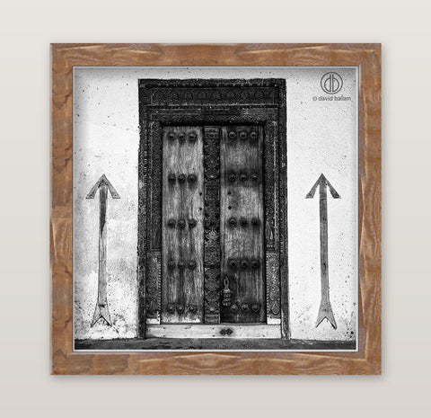 Black-and-white fine art photo by david ballam of an ornate double wooden door with intricate carvings and metal studs