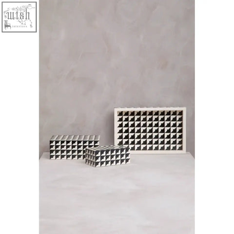 White ceramic wine rack with square compartments featured on davino black and white tray with raised edges