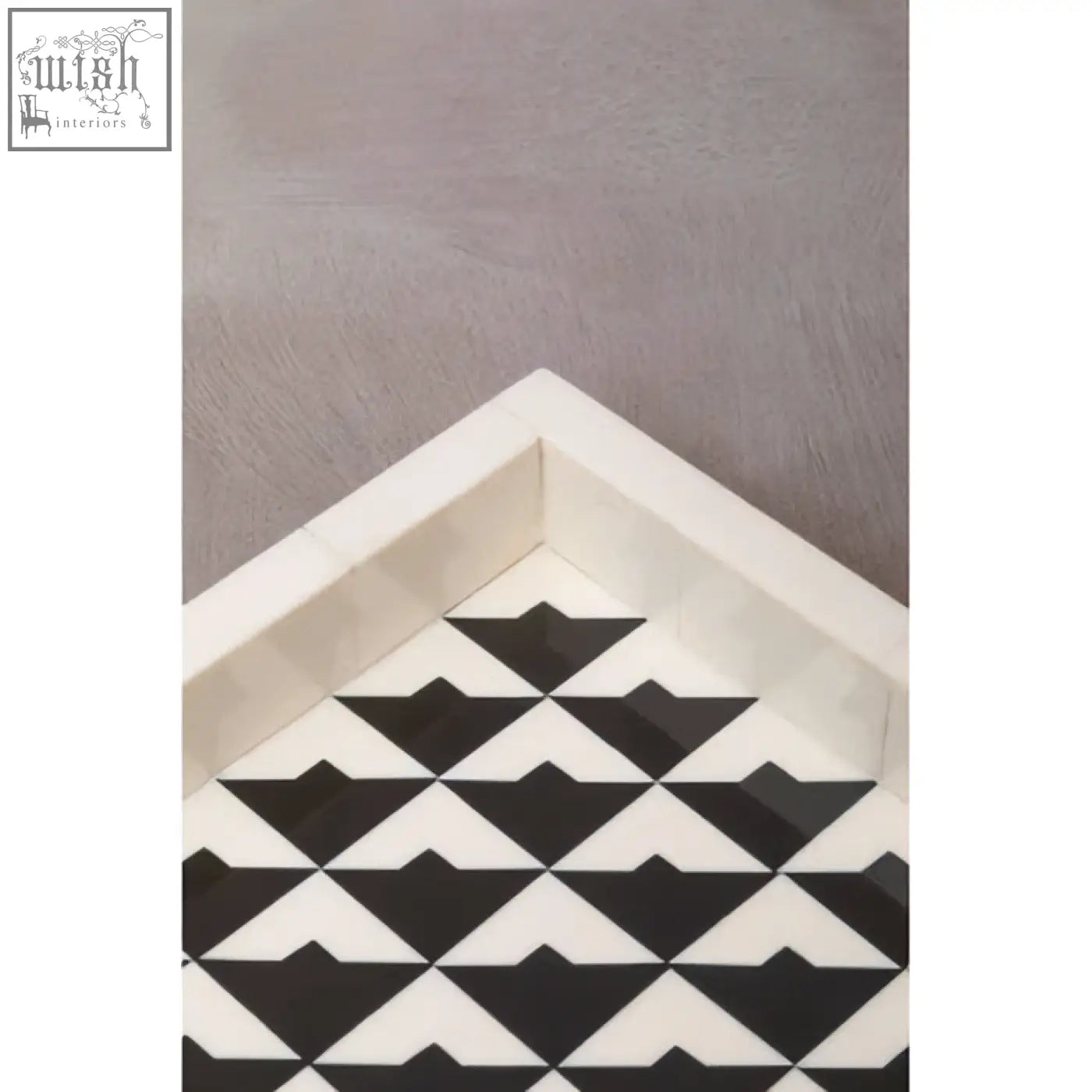 Davino black and white tray with raised edges featuring a white and black geometric triangular pattern