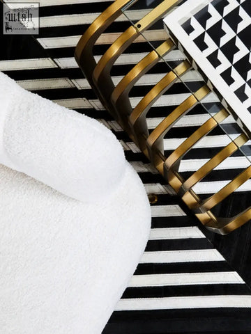 Davino black and white tray with raised edges featuring a gold-toned metal basket and a striped surface beneath
