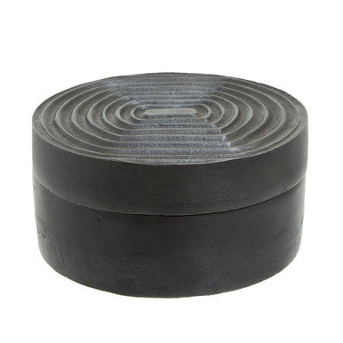 Black circular dax small grey box with concentric ring patterns on the lid featuring a sleek grey design