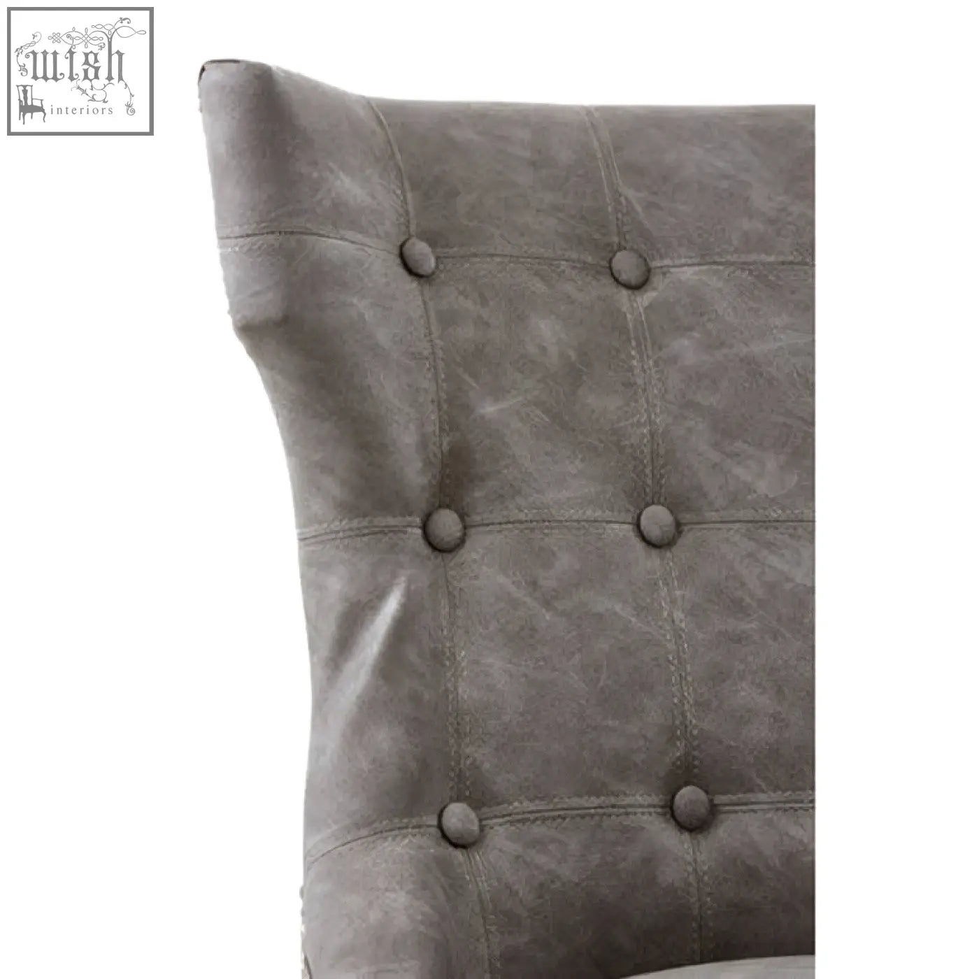 Daxton grey leather dining chair with gray tufted leather pillow and subtle button details on black rubberwood legs