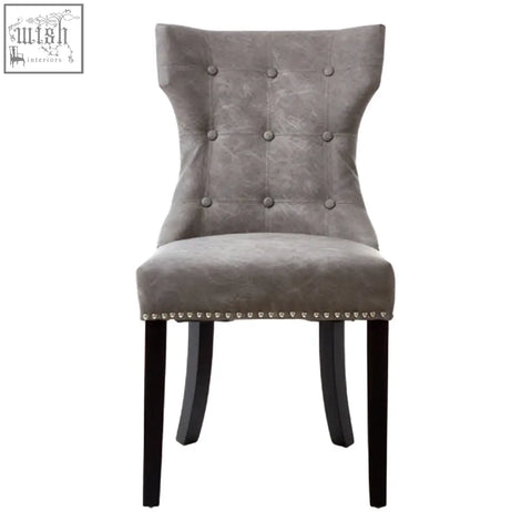 Daxton grey leather dining chair with gray tufted velvet upholstery and black rubberwood legs with nailhead trim