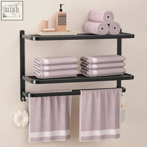 Black metal stainless steel towel rack with three shelves and two bars holding lavender-striped towels for bathroom use