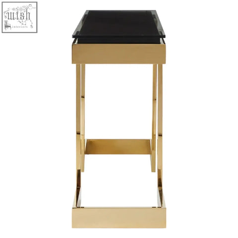 Gold-finished metal bar stool with sleek black glass top complements deana gold black console table design