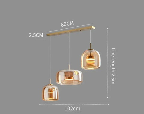 Modern amber glass pendant lights with brass-finished bar and three spherical shades by decao light