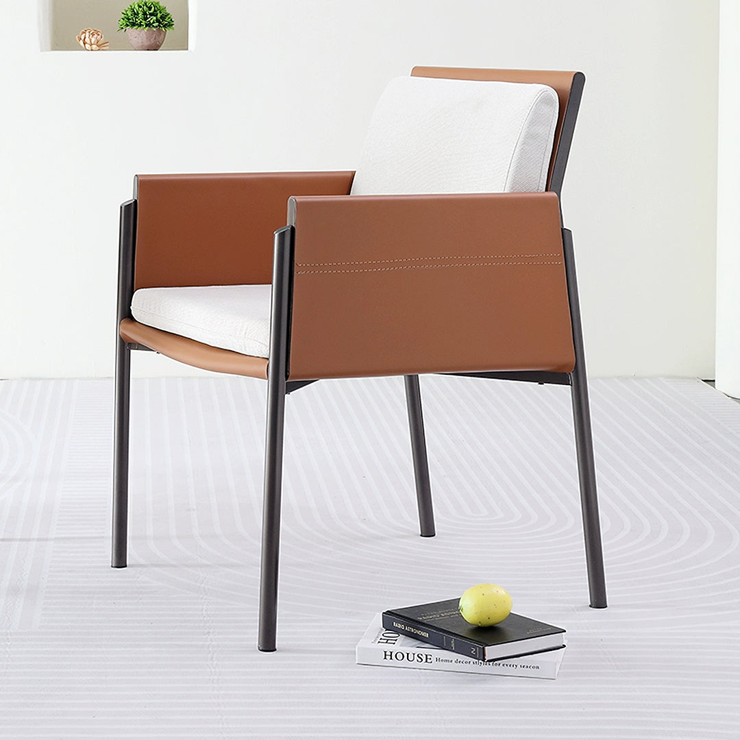 Modern decker dining chair with brown leather upholstery white cushioning and black metal frame for sleek dining look