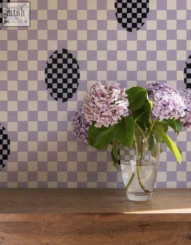 A clear glass vase with light purple hydrangeas complements micaela sharp violet veil wallpaper with digital printing