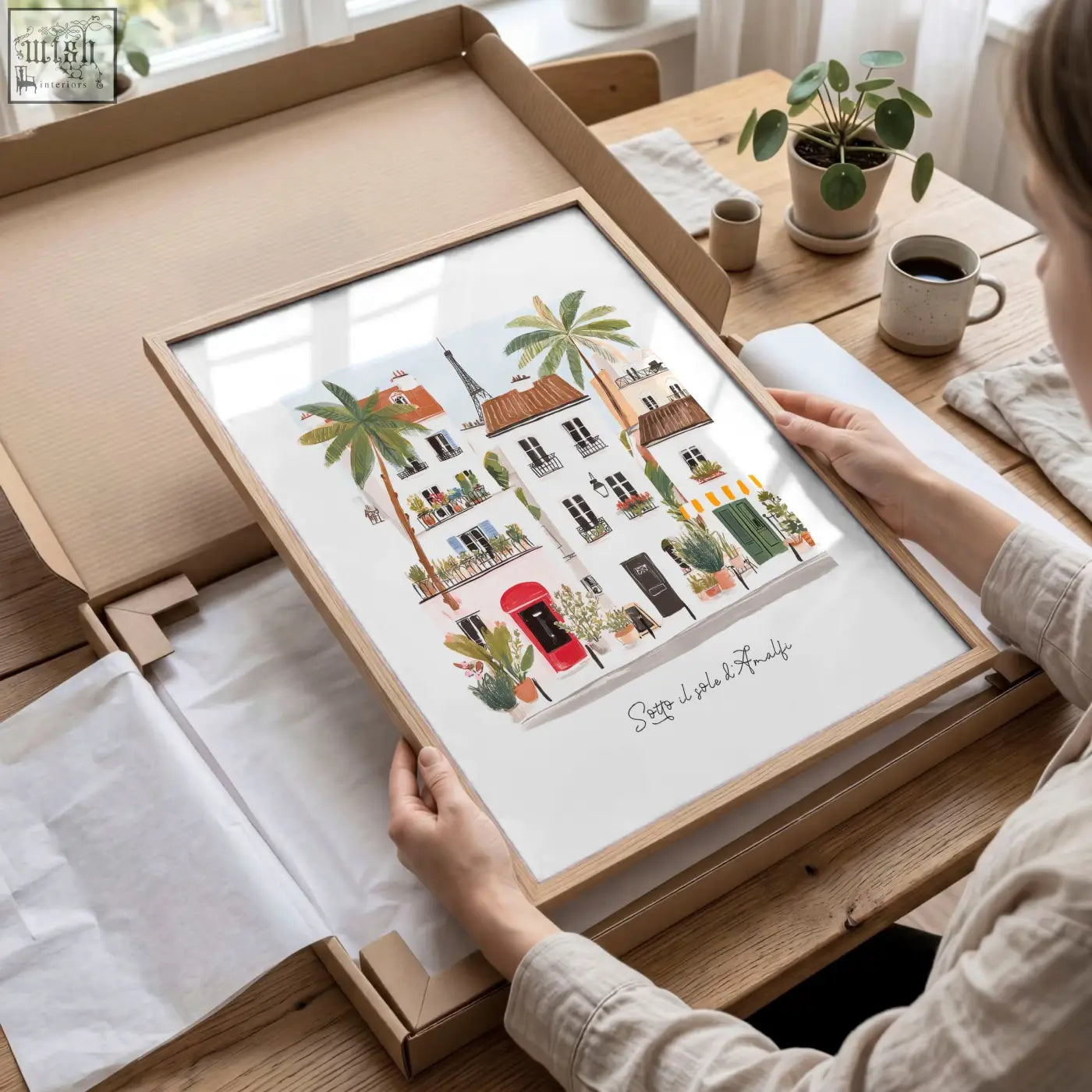 A framed wall art print of a charming parisian street scene in soft watercolor tones from sotto il sole set