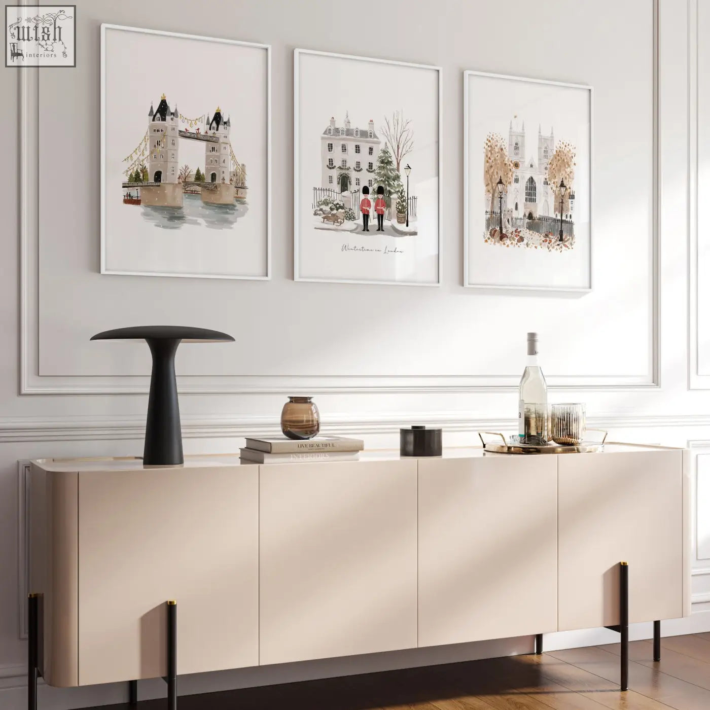Cream-colored sideboard with sleek minimalist design and black legs below decorative wall hangings for living room london bridge art prints wintertime in london set of 3