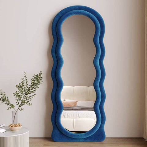 Deenz modern full length mirror with a striking cobalt blue velvet frame and wavy sculptural border design