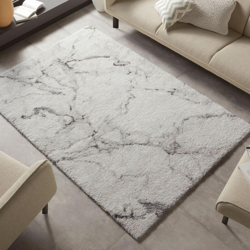 A deep-pile velour rug cream colour with a plush white base and gray marble pattern for cozy living spaces
